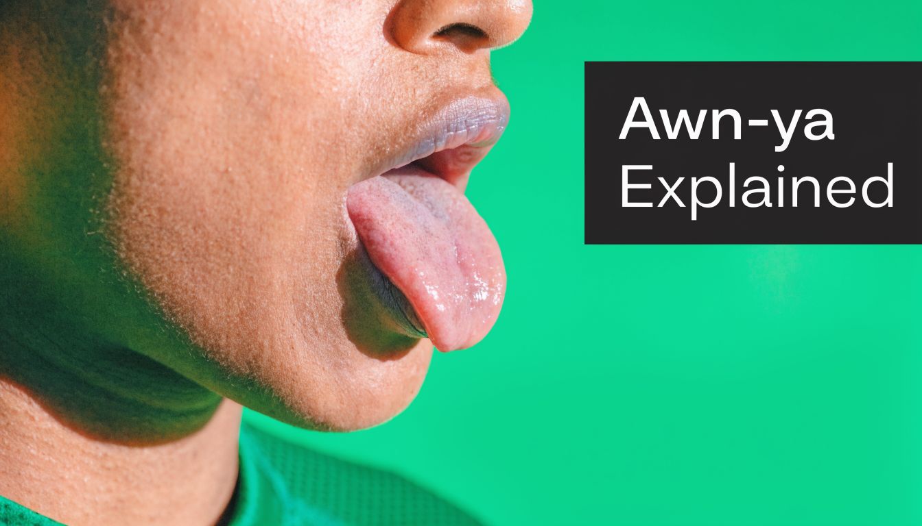 A close-up side view of a person sticking out their tongue against a bright green background.