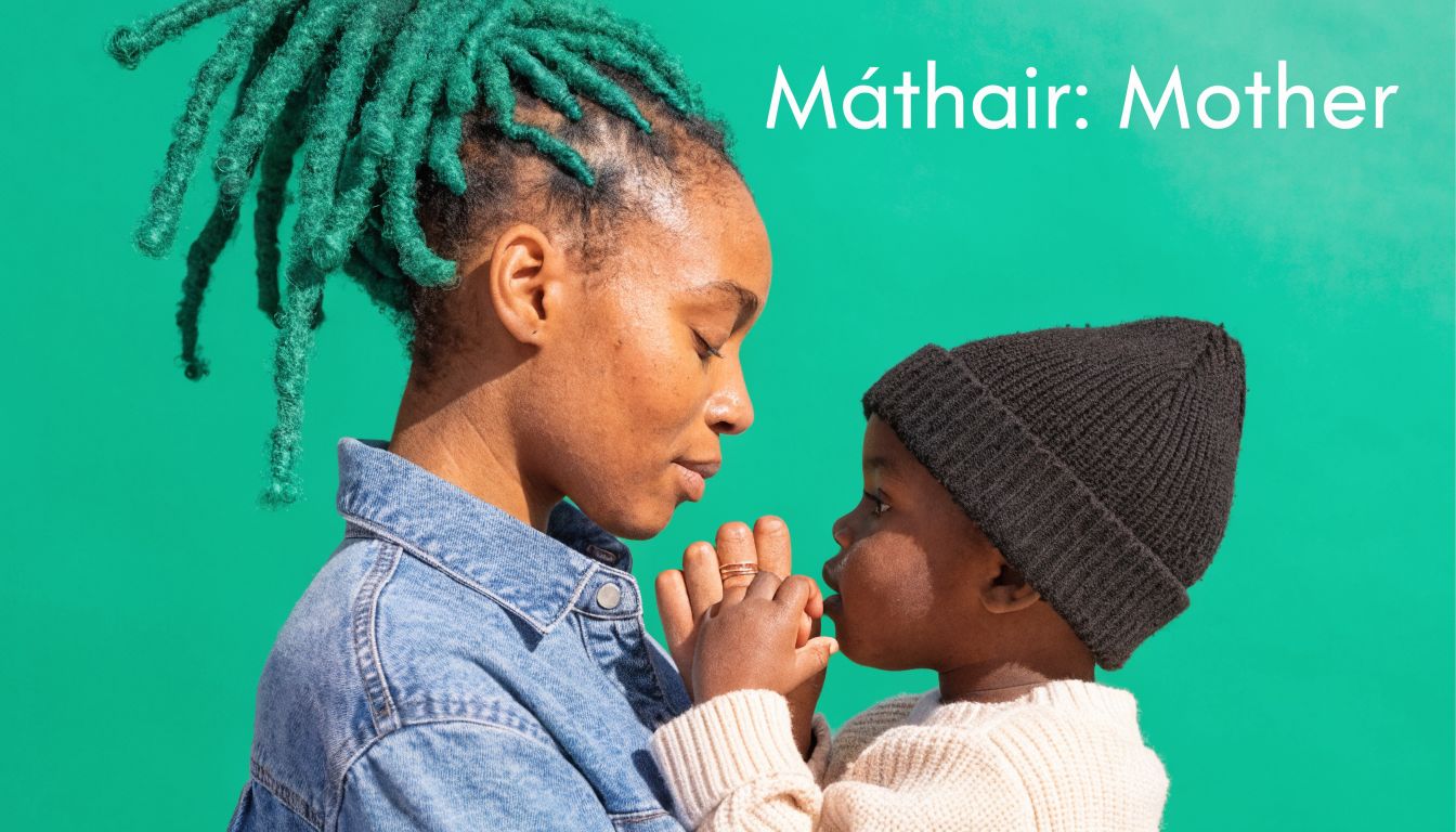 A close-up profile view of a mother with bright green dreadlocks holding her young child.