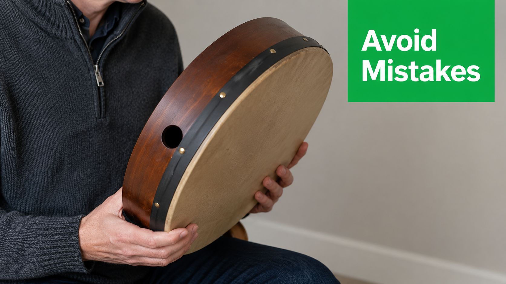 A man holding a traditional Irish bodhran drum, demonstrating the correct way to handle the instrument.