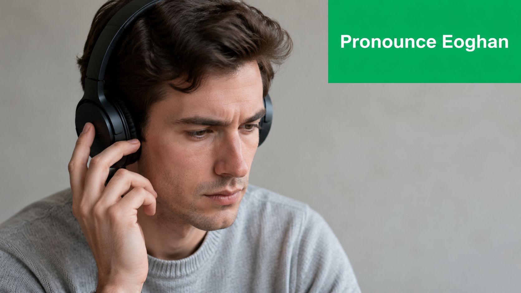 A young man wearing headphones listening intently while looking down, next to the green text Pronounce Eoghan.