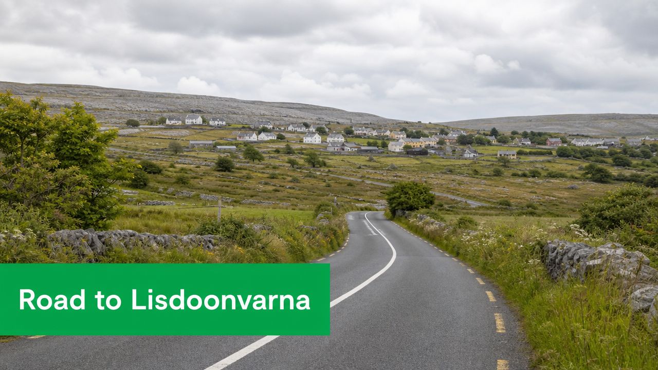 A scenic, winding asphalt road leads towards the charming village of Lisdoonvarna nestled in the Irish hills.
